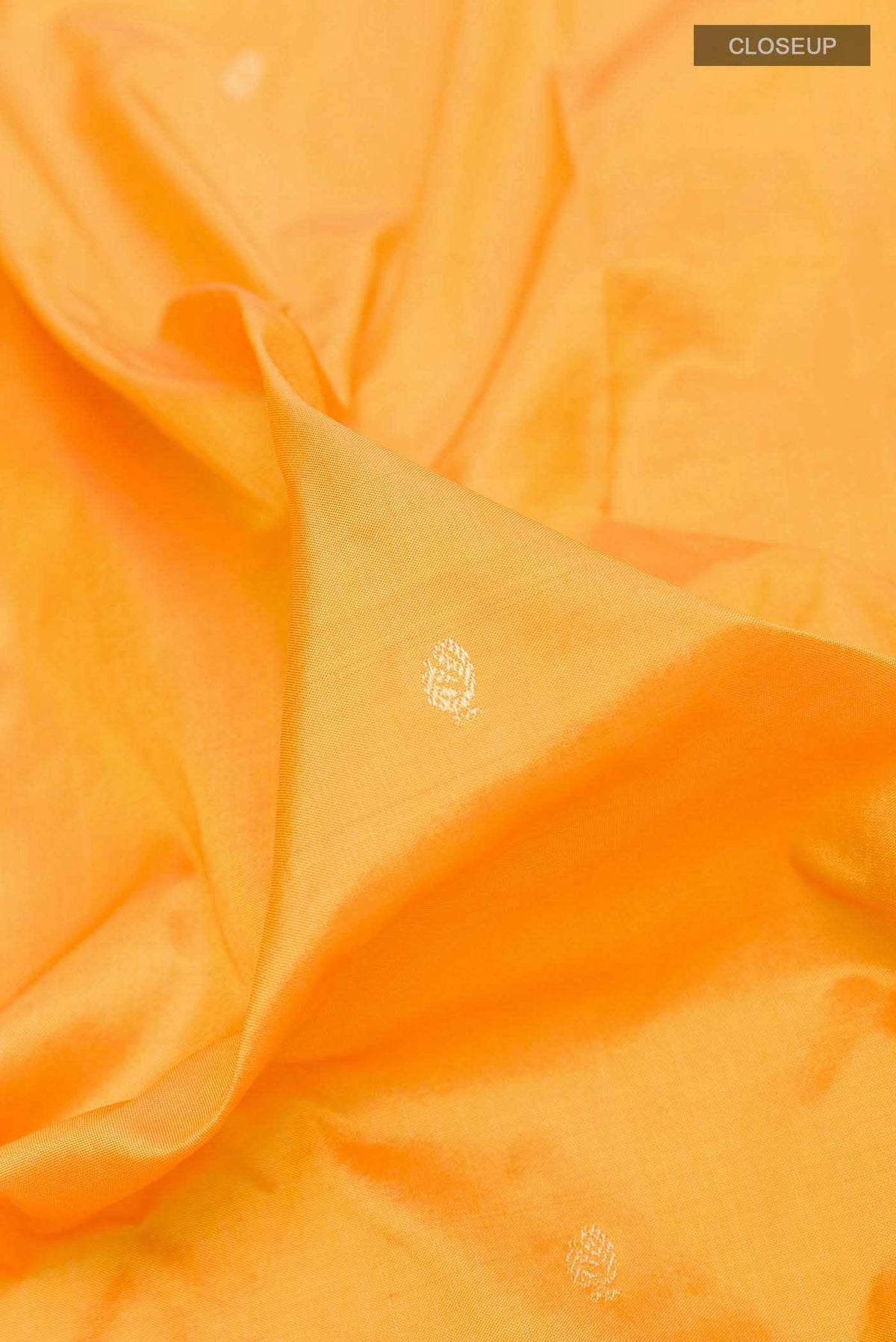 Close up of Yellow Dual Tone Paithani Silk Saree with Zari Butta on the body and Zari Border displaying folds