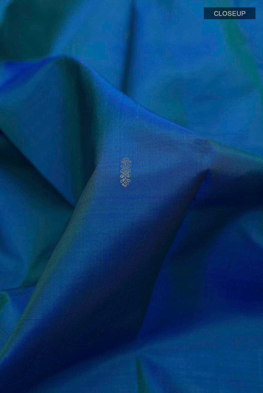 Close up of Blue Kanchipuram Silk Saree with Zari Butta on the body and Zari Border displaying folds