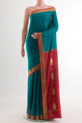 Teal Mysore Crepe Saree with Zari Butta on the body and Zari Border.  displayed on a mannequin
