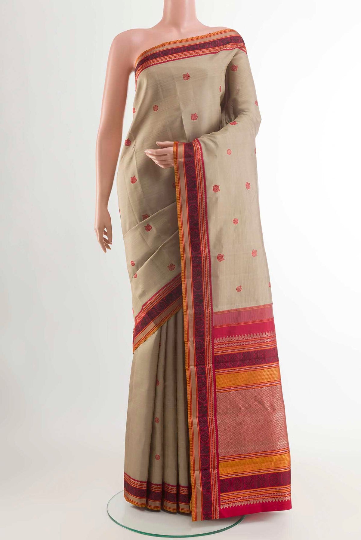 Beige Kanchipuram Silk Saree with Thread Butta on the body and Thread Border displayed on a mannequin