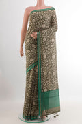 Mehandi Green Tussar Saree with Printed design on the body and Zari Border.  displayed on a mannequin
