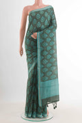 Green Tussar Silk Saree with Floral Print on the body and Zari Border displayed on a mannequin