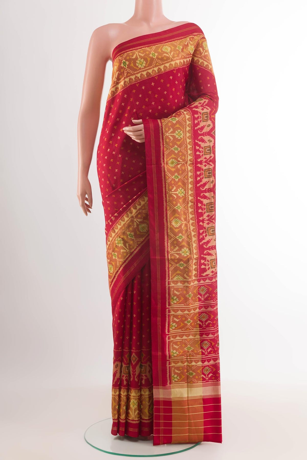 Red Rajkot Patola Silk Saree with Ikat design on the body and Zari Border.  displayed on a mannequin