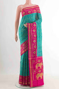 Green Rajkot Patola Silk Saree with Pure Ikat on the body and Zari Border.  displayed on a mannequin