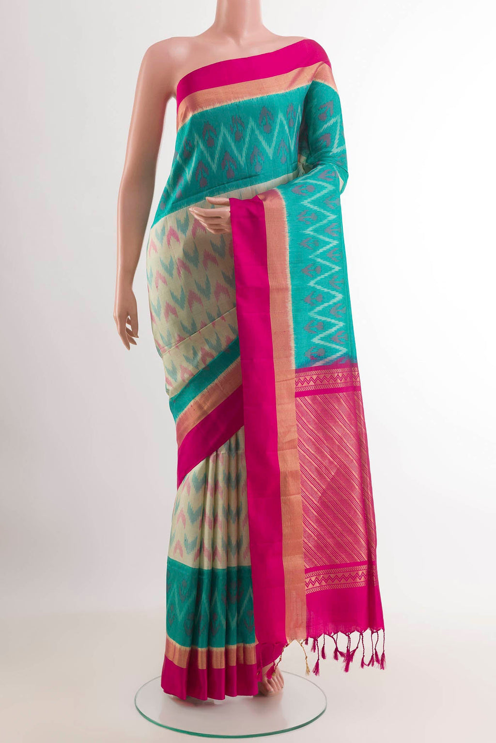 Cream Soft Silk Saree with Ikat design on the body and Zari Border.  displayed on a mannequin