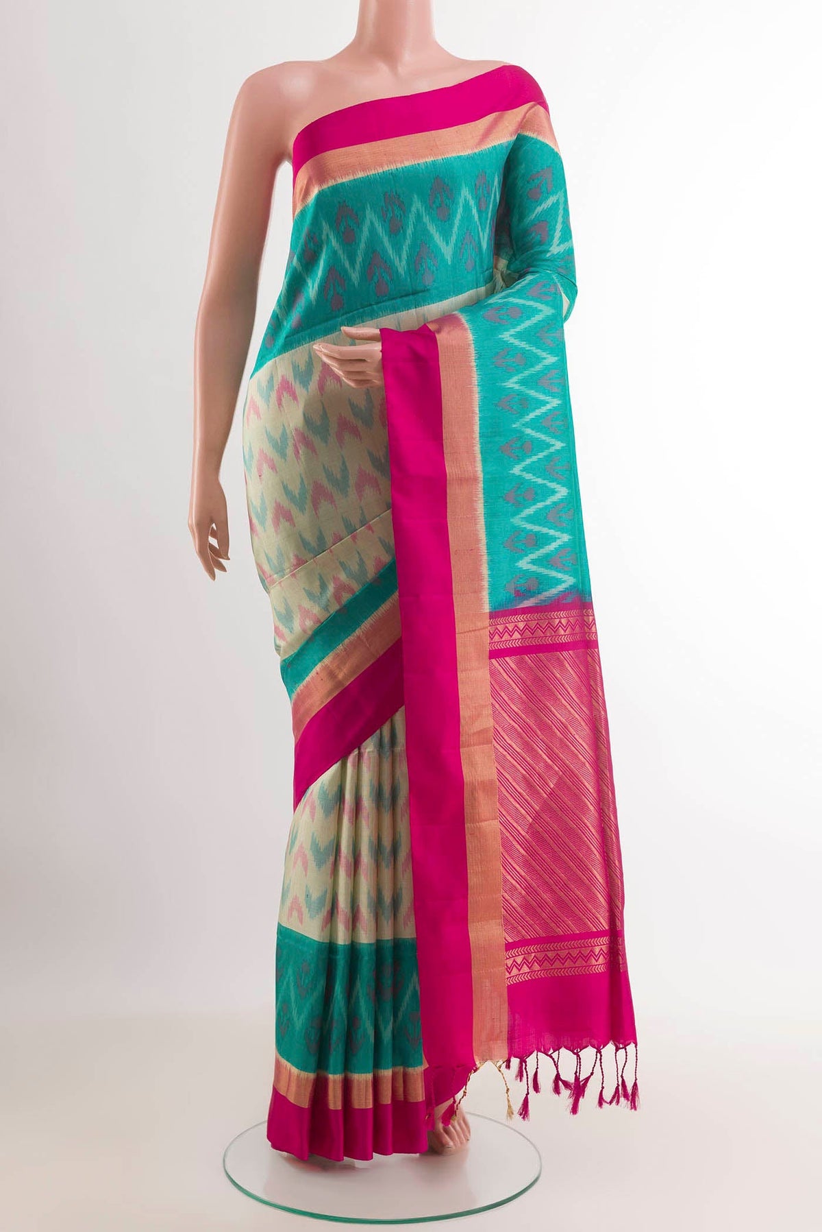 Cream Soft Silk Saree with Ikat design on the body and Zari Border.  displayed on a mannequin