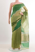 Green Banarasi Kora Silk Saree with Zari Butta on the body and Zari Border.  displayed on a mannequin