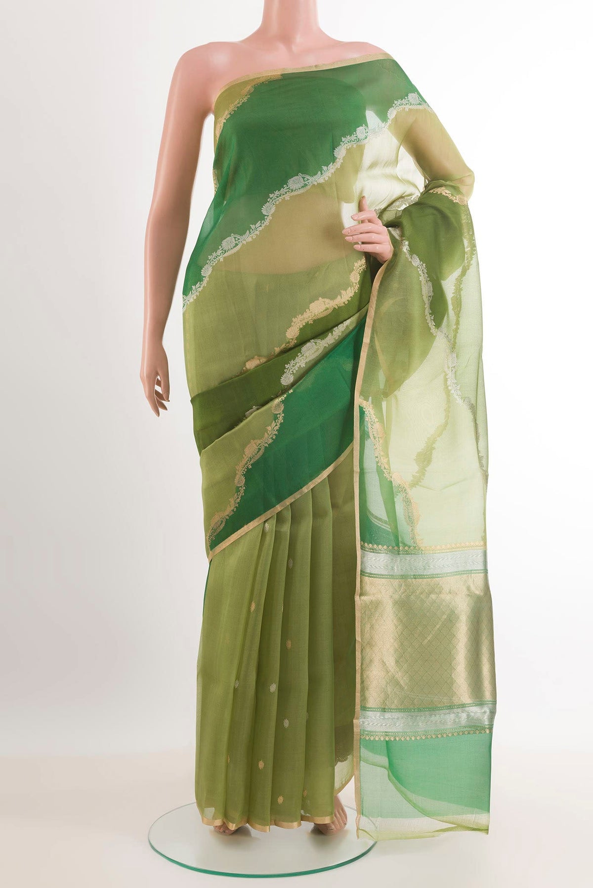 Green Banarasi Kora Silk Saree with Zari Butta on the body and Zari Border.  displayed on a mannequin