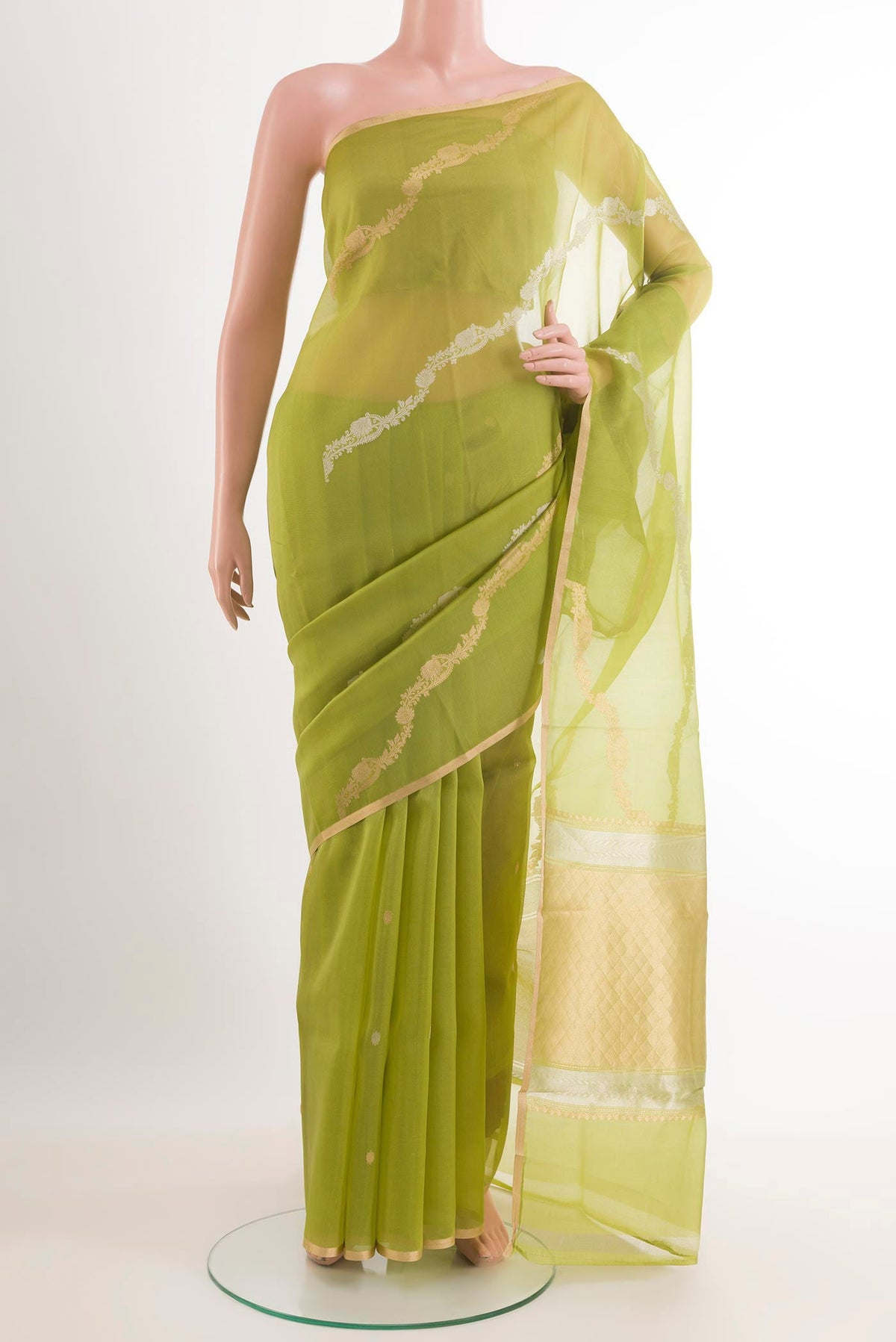 Green Banarasi Kora Silk Saree with Zari Butta on the body and Zari Border.  displayed on a mannequin