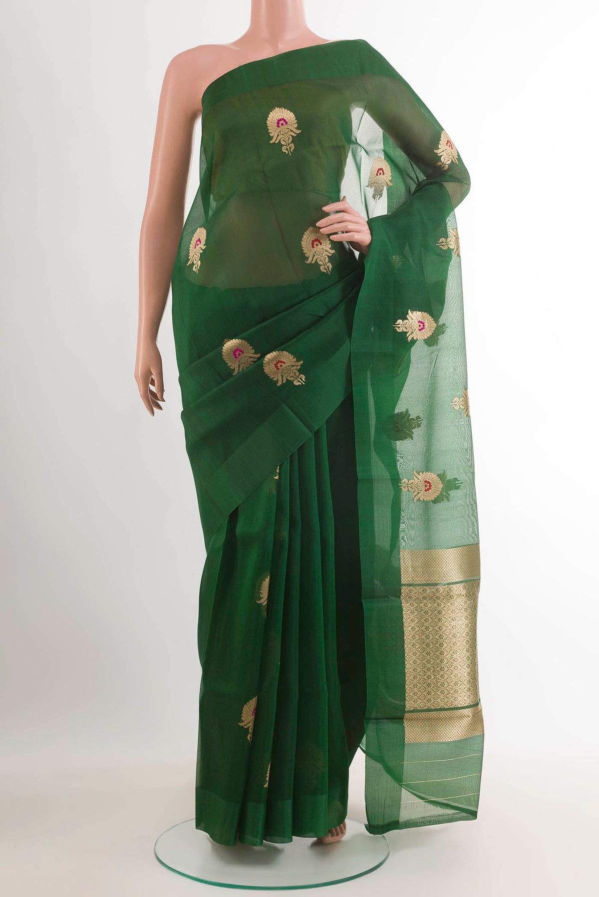 Green Banarasi Kora Silk Saree with Zari Butta on the body and Zari Border.  displayed on a mannequin