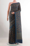 Blue Printed Silk Saree with Printed design on the body and Plain Border.  displayed on a mannequin