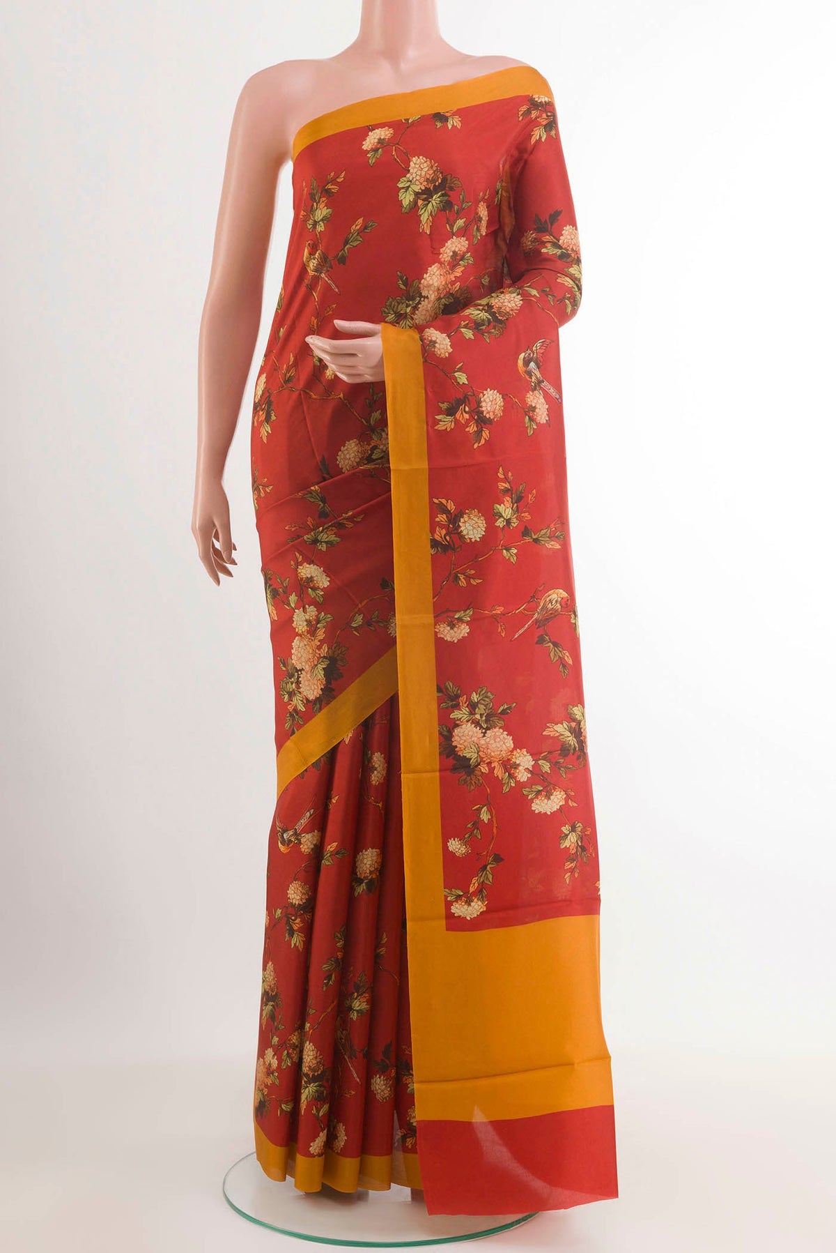 Red Printed Silk Saree with Printed design on the body and Plain Border.  displayed on a mannequin