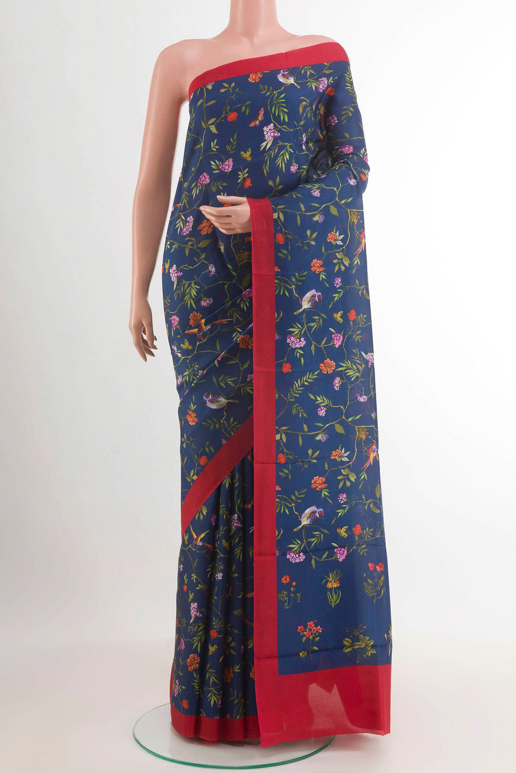 Blue Printed Silk Saree with Printed design on the body and Printed Border.  displayed on a mannequin