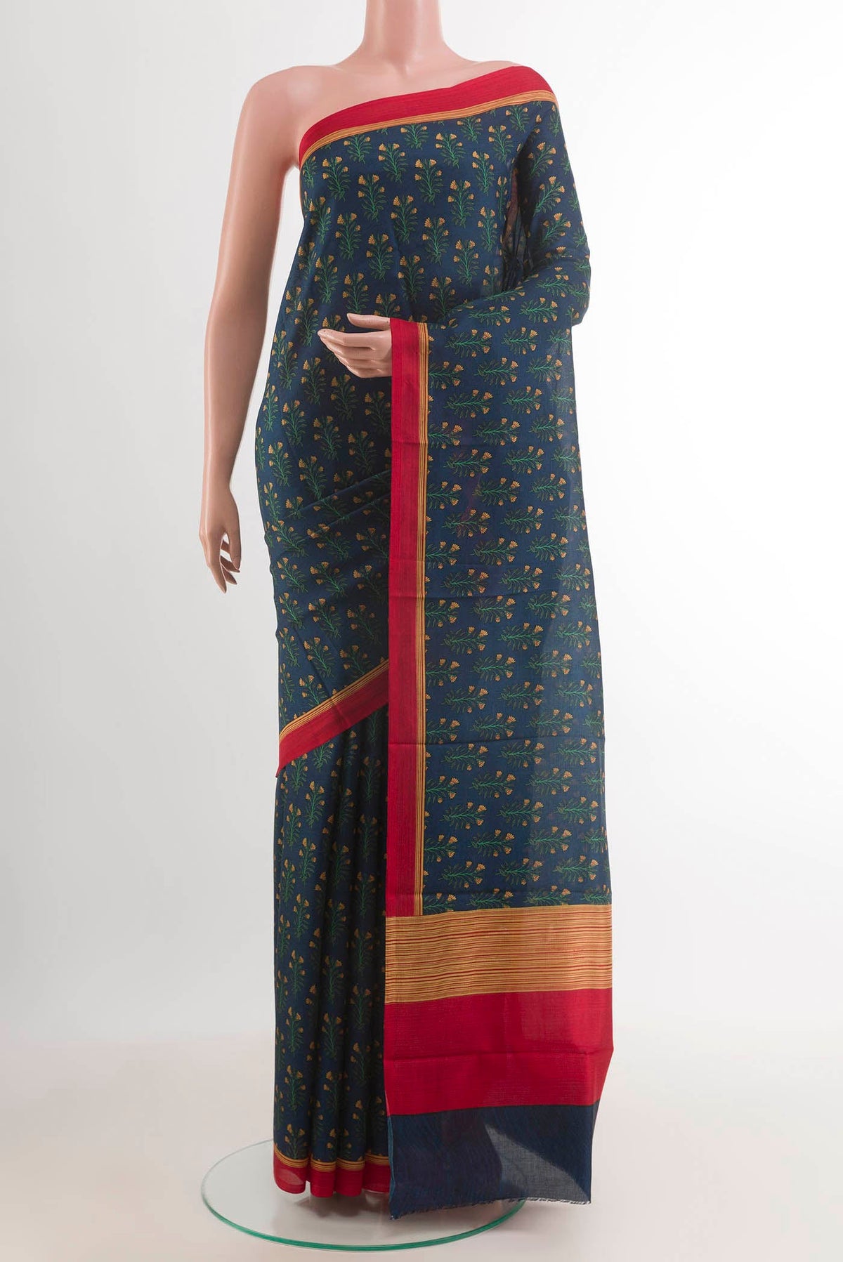 Blue Printed Silk Saree with Printed design on the body and Printed Border.  displayed on a mannequin