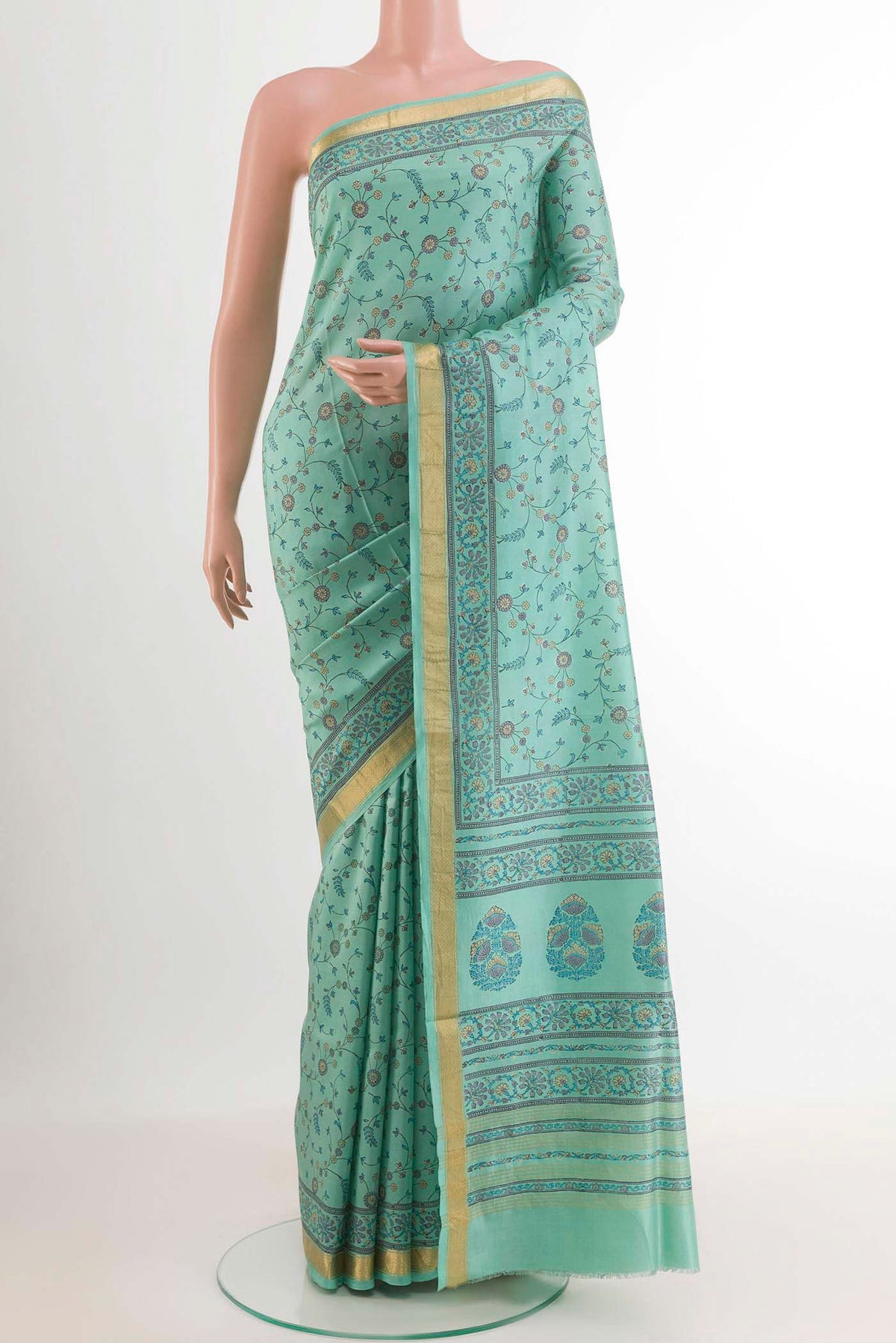Blue Printed Silk Saree with Printed design on the body and Zari Border.  displayed on a mannequin