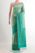 Sage Green Soft Silk Saree with Zari Butta on the body and Zari Border.  displayed on a mannequin