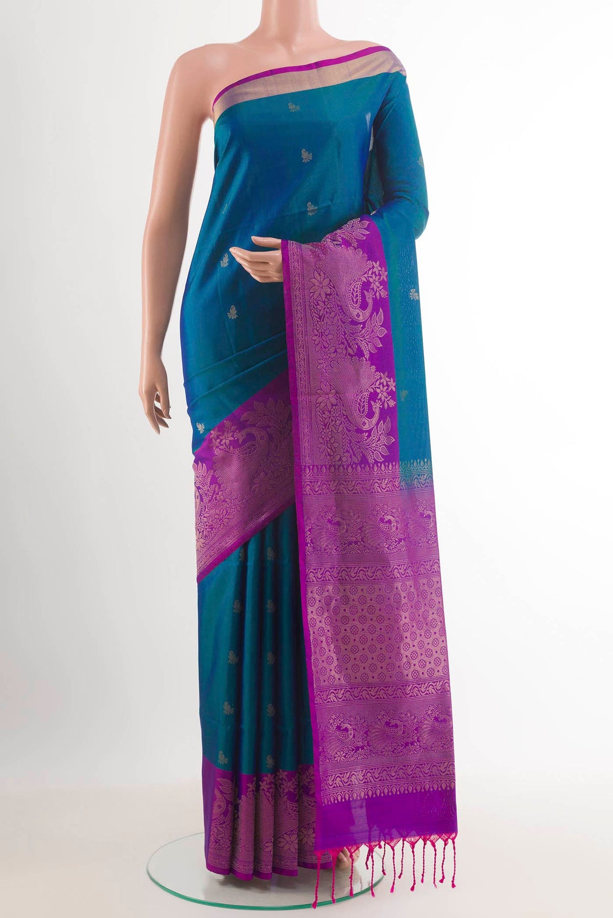 Peacock Blue Soft Silk Saree with Zari Butta on the body and Zari Border.  displayed on a mannequin