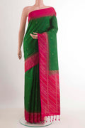 Green Soft Silk Saree with Zari Butta on the body and Zari Border.  displayed on a mannequin
