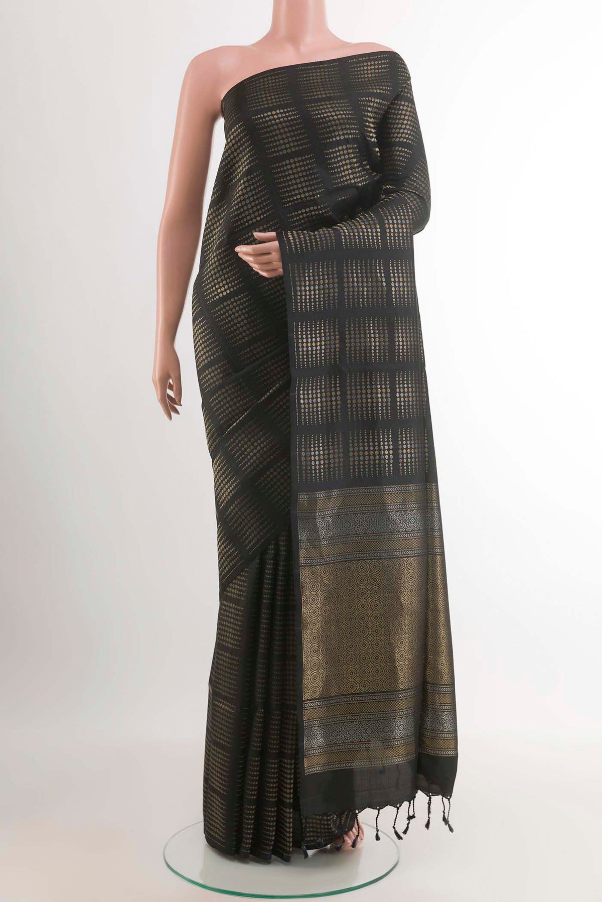 Black Soft Silk Saree with Zari Butta on the body and Zari Border.  displayed on a mannequin