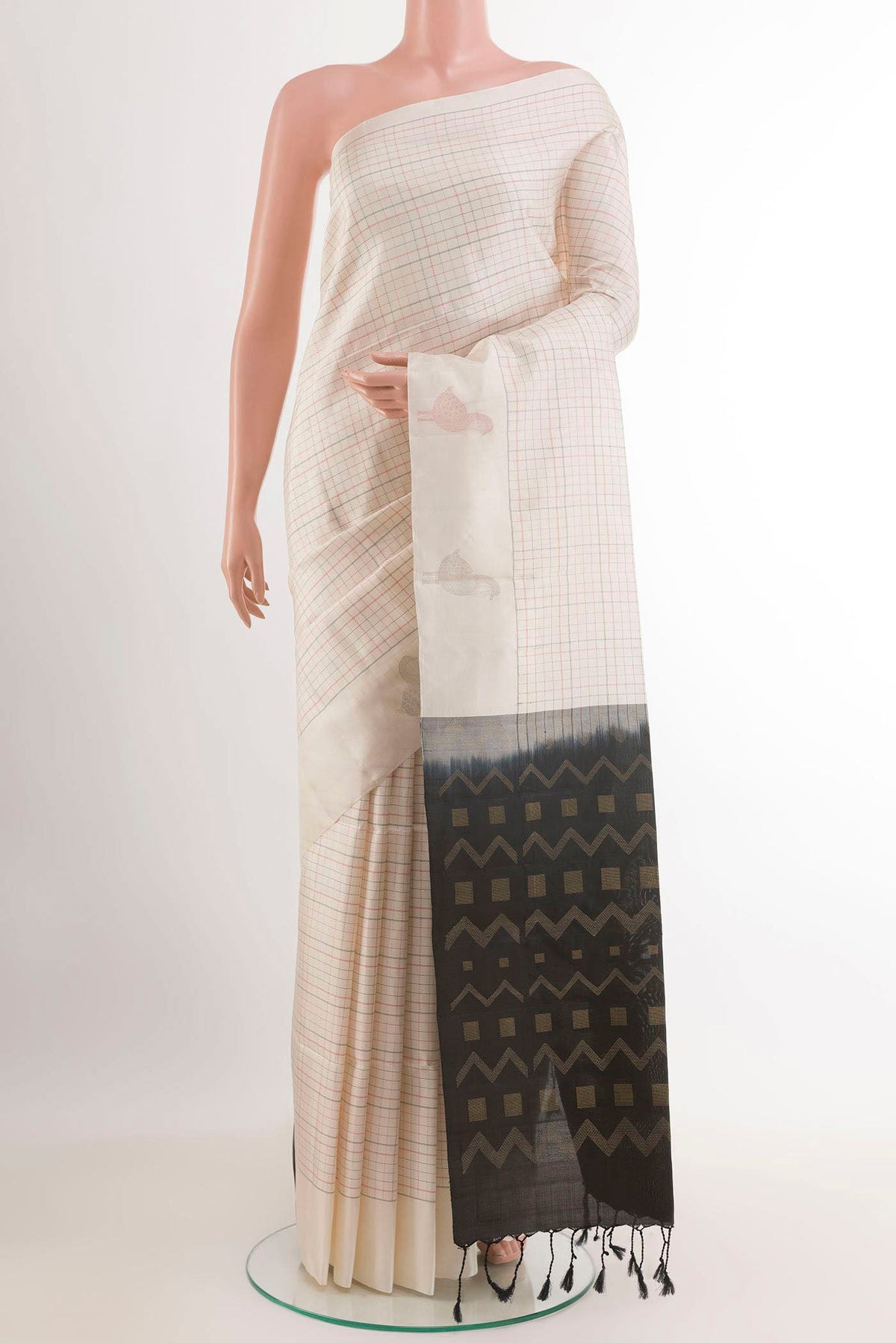Off White Soft Silk Saree with Checked design on the body and Zari Border.  displayed on a mannequin