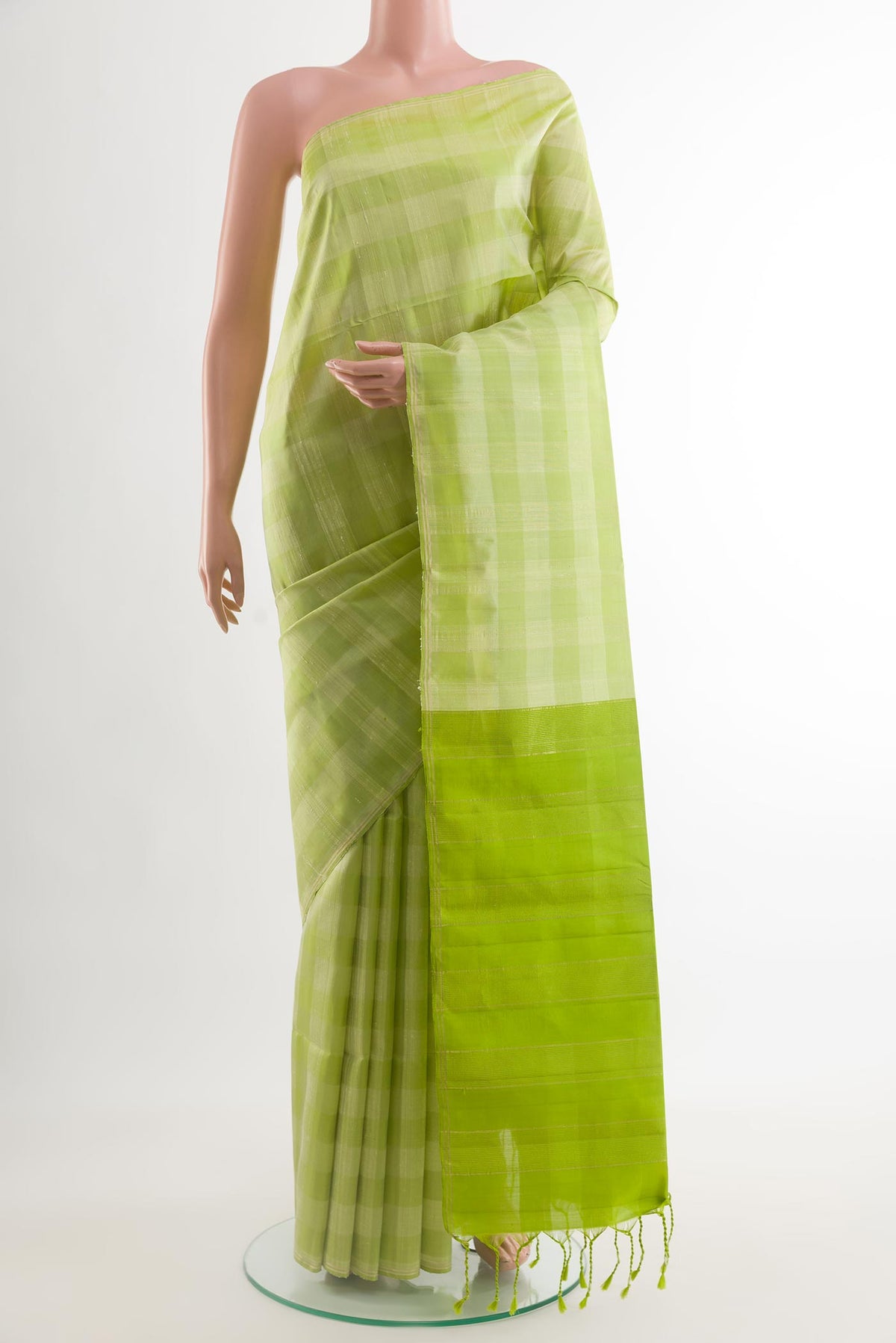 Light Green Soft Silk Saree with Checked design on the body and Zari Border.  displayed on a mannequin