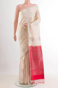 Off White Soft Silk Saree with Zari Butta on the body and Zari Border.  displayed on a mannequin