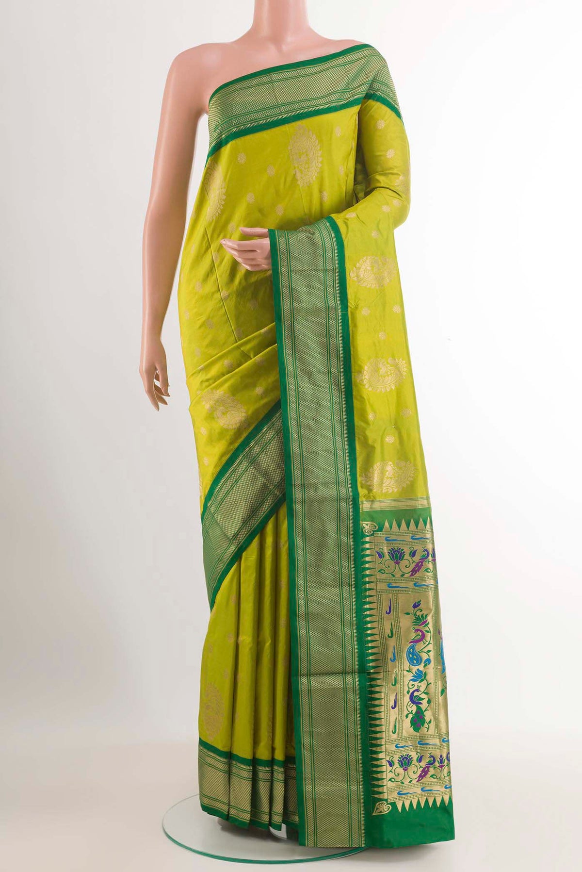 Green Soft Silk Saree with Zari Butta on the body and Zari Border.  displayed on a mannequin