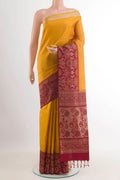 Yellow Soft Silk Saree with Zari Butta on the body and Zari Border.  displayed on a mannequin
