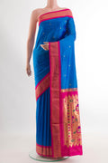 Blue Paithani Silk Saree with Zari Butta on the body and Zari Border.  displayed on a mannequin