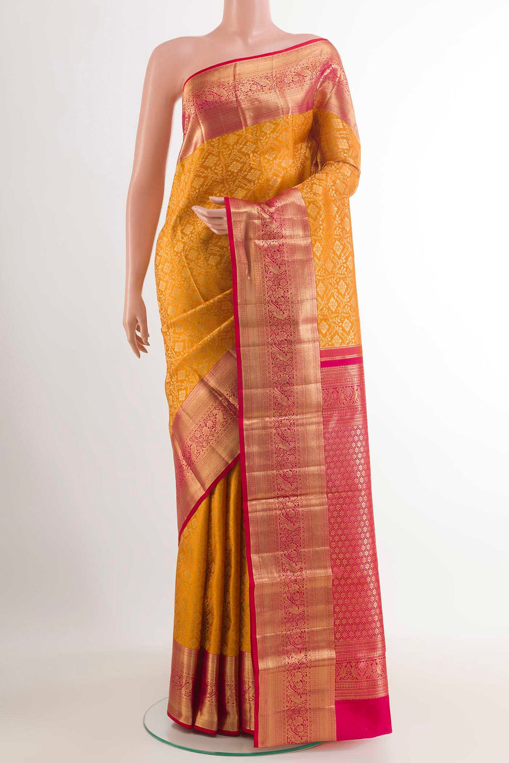 Yellow Kanchipuram Silk Saree with Zari Brocade on the body and Zari Border.  displayed on a mannequin