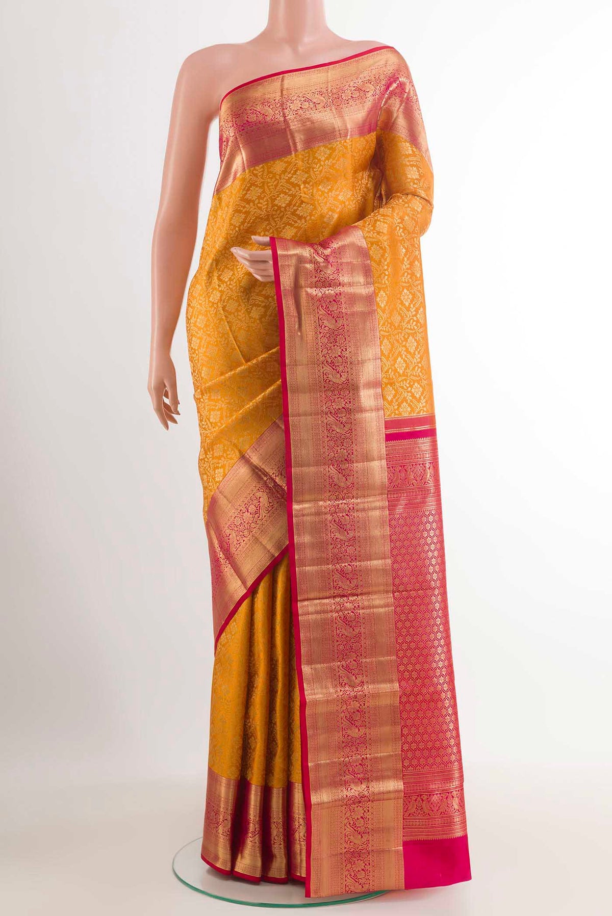 Yellow Kanchipuram Silk Saree with Zari Brocade on the body and Zari Border.  displayed on a mannequin
