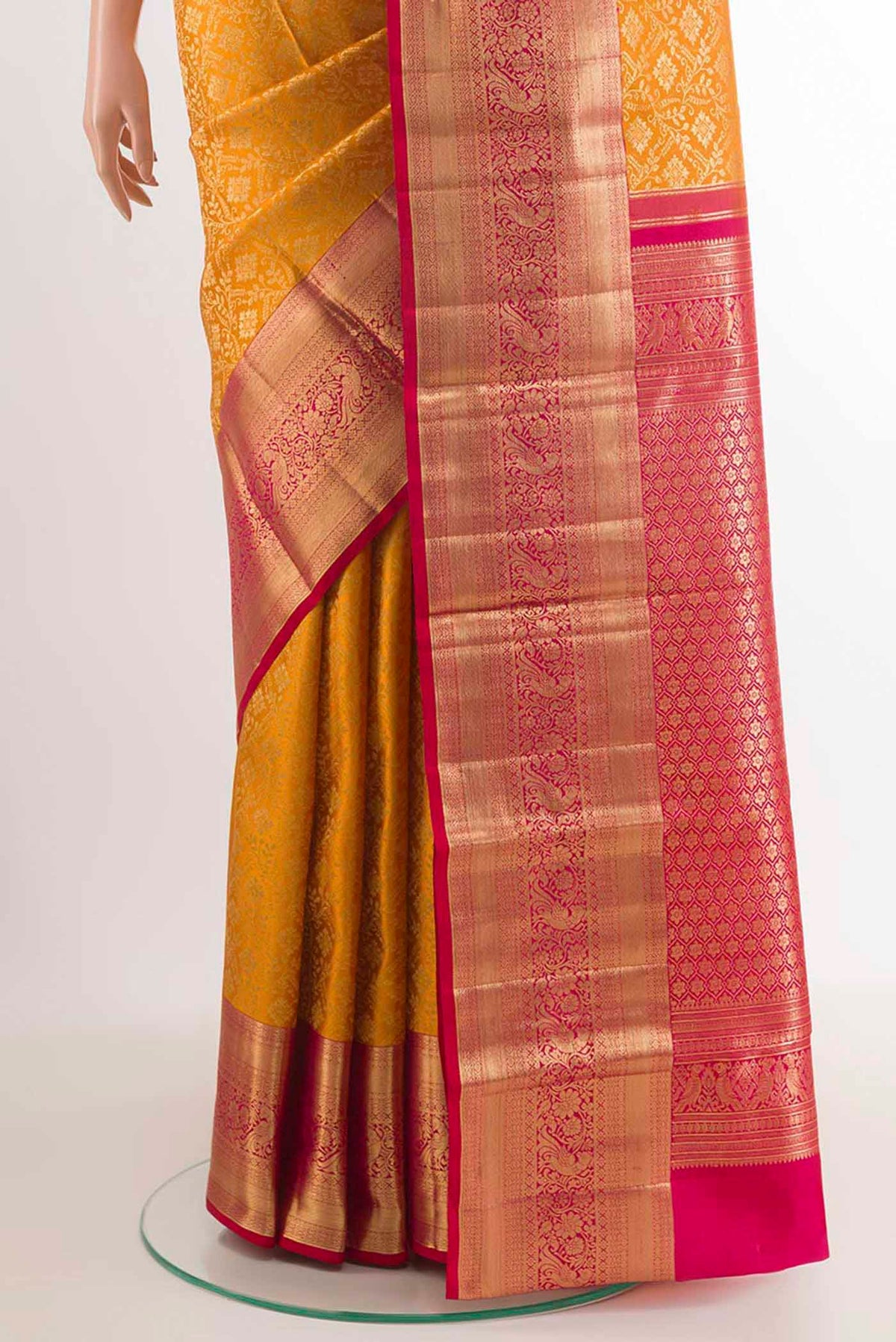 Pleats and pallu of Yellow Kanchipuram Silk Saree with Zari Brocade on the body and Zari Border. 