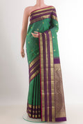 Green Kanchipuram Silk Saree with Zari Brocade on the body and Zari Border.  displayed on a mannequin