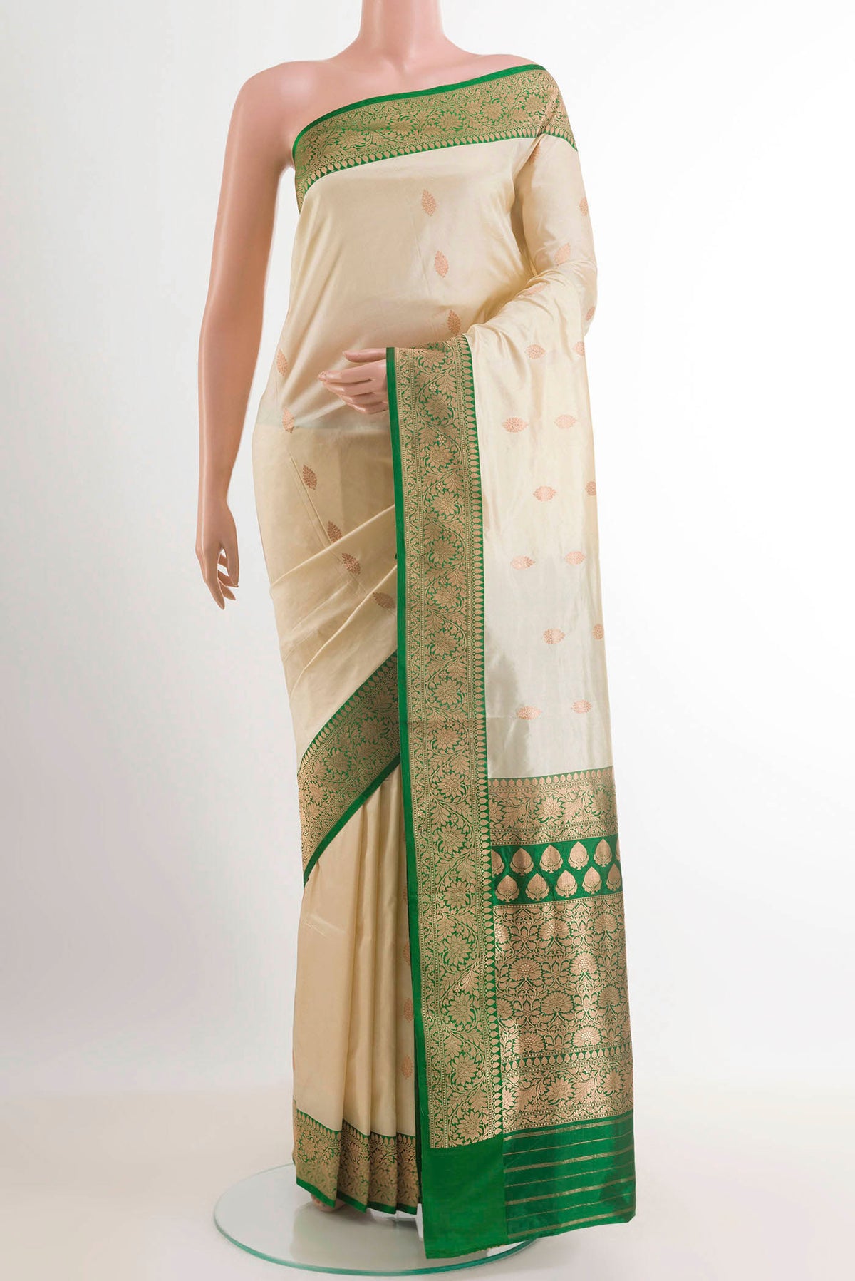 Cream Banarasi Silk Saree with Zari Butta on the body and Zari Border.  displayed on a mannequin