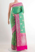 Green Banarasi Silk Saree with Zari Butta on the body and Zari Border.  displayed on a mannequin