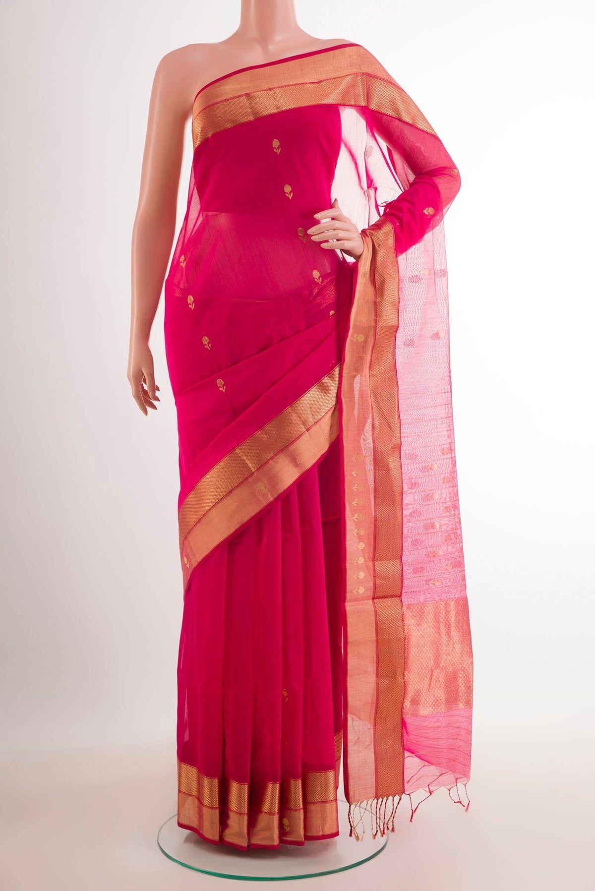 Rani Pink Blended Kora Cotton Saree with Zari Butta on the body and Zari Border.  displayed on a mannequin