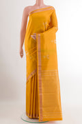 Yellow Kanchipuram Silk Saree with Zari Butta on the body and Zari Border.  displayed on a mannequin