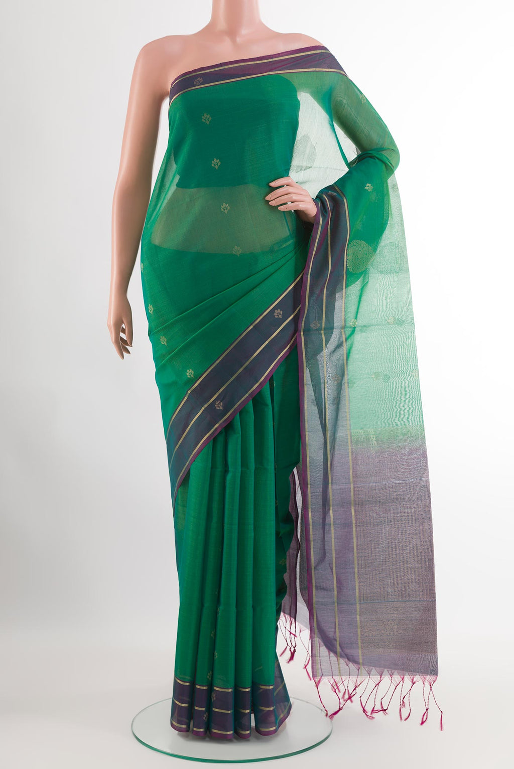 Green Blended Kora Cotton Saree with Zari Butta on the body and Zari Border.  displayed on a mannequin