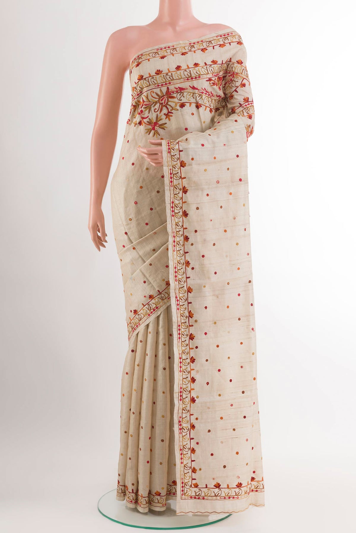Off White Tussar Saree with Embroidery on the body and Embroidery Border.  displayed on a mannequin