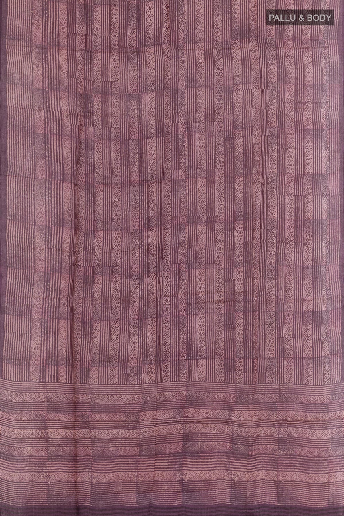 Flat view of Purple Tussar Saree with Printed design on the body and Printed Border. 