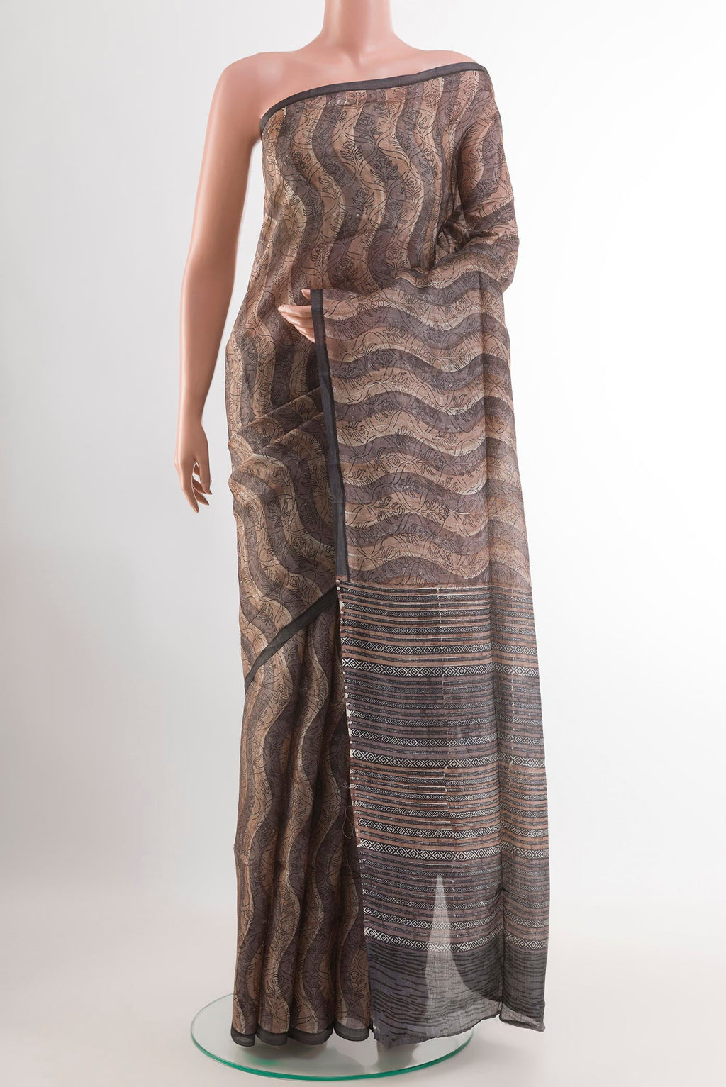 Grey Tussar Saree with Printed design on the body and Printed Border.  displayed on a mannequin