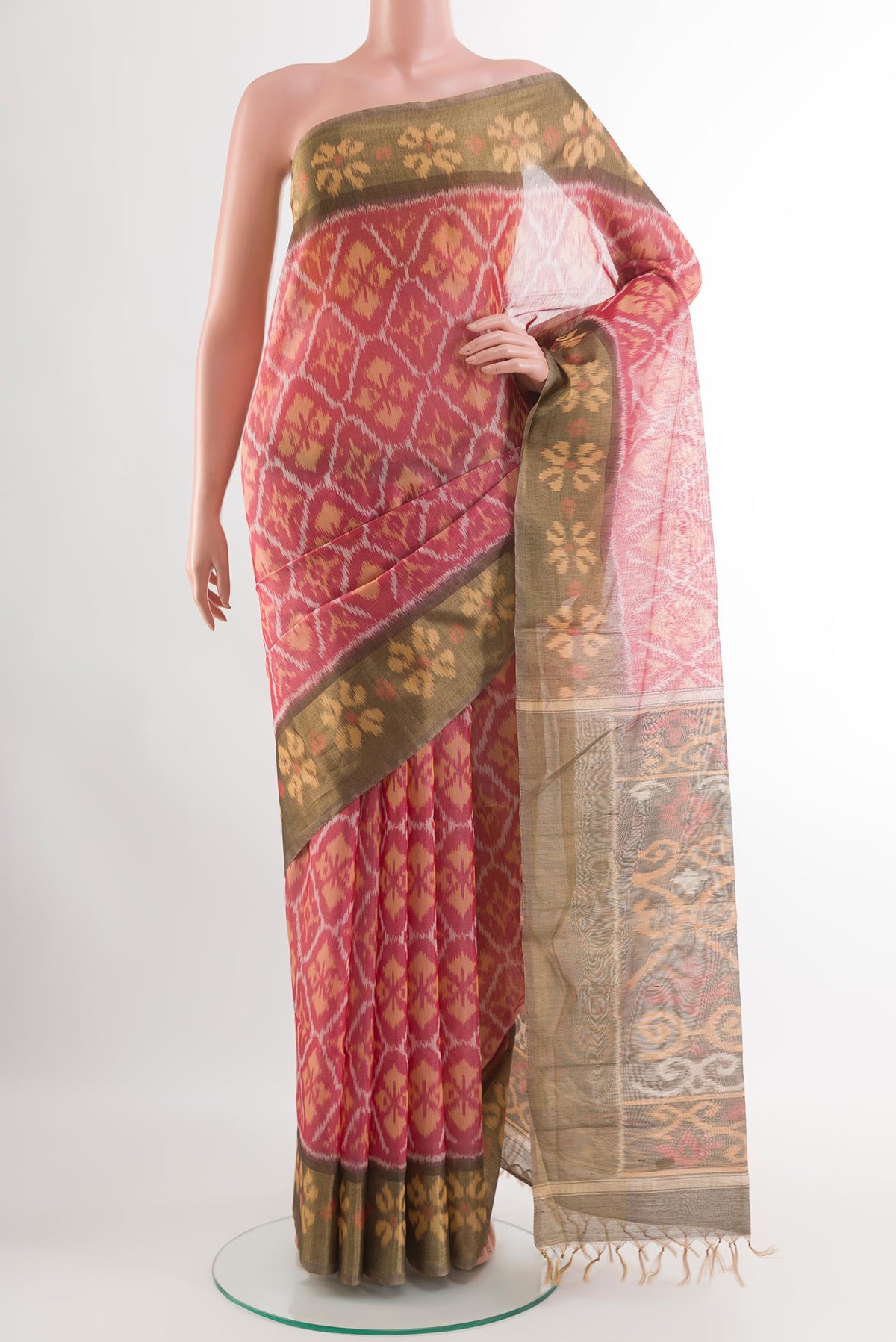 Red Blended Kora Cotton Saree with Ikat design on the body and Zari Border.  displayed on a mannequin