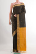 Black Soft Silk Saree with Zari Butta on the body and Zari Border.  displayed on a mannequin