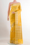 Yellow Tussar Silk Saree with Zari Butta on the body and Zari Border.  displayed on a mannequin