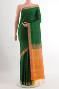 Green Soft Silk Saree with Zari Butta on the body and Zari Border.  displayed on a mannequin