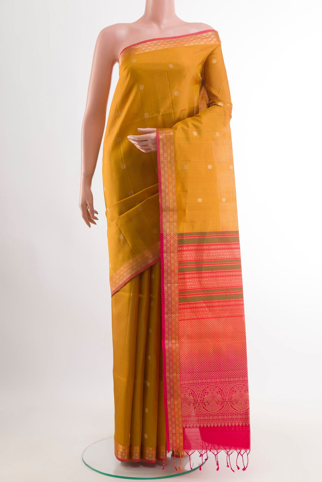 Yellow Soft Silk Saree with Zari Butta on the body and Zari Border.  displayed on a mannequin