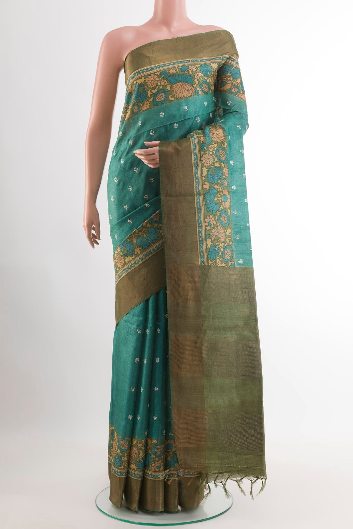 Sea Green Tussar Saree with Thread Butta on the body and Zari Border.  displayed on a mannequin