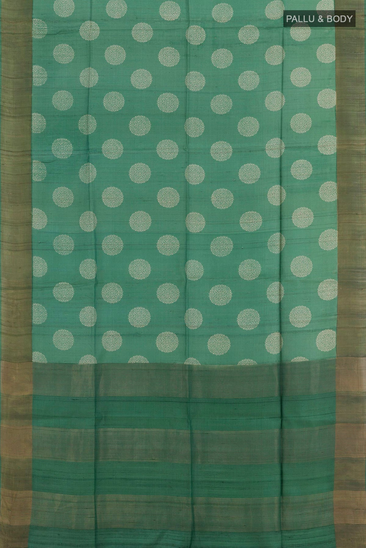 Flat view of Green Tussar Saree with Printed design on the body and Zari Border. 