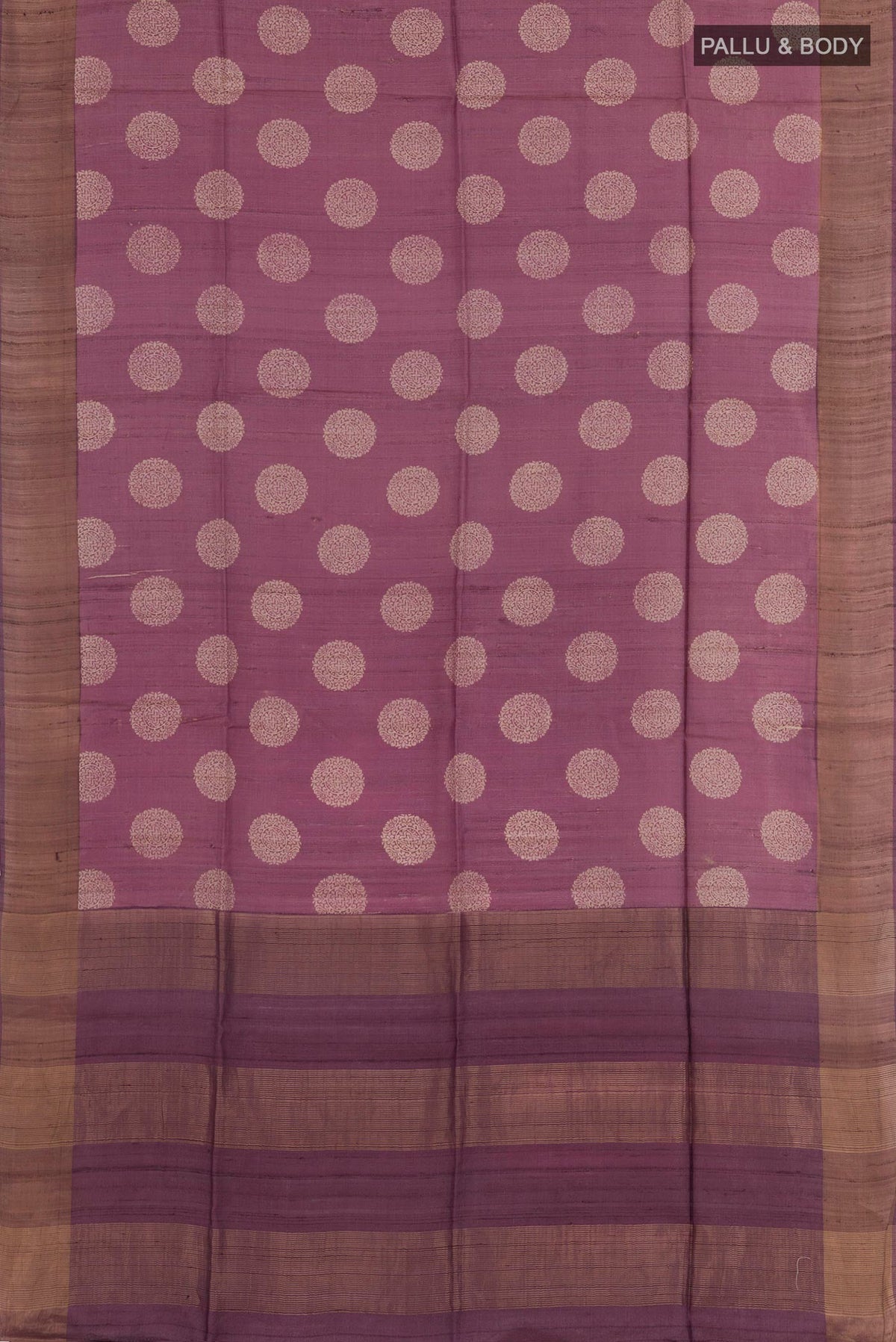 Flat view of Purple Tussar Saree with Printed design on the body and Zari Border. 
