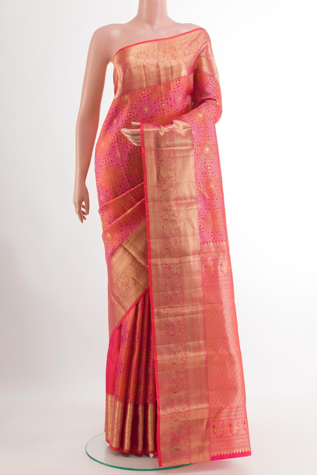 Orange Kanchipuram Silk Saree with Zari Brocade on the body and Zari Border.  displayed on a mannequin